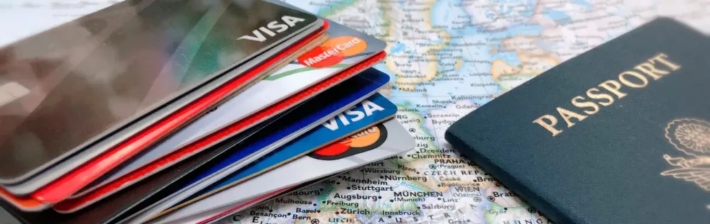 passport and credit cards on map.